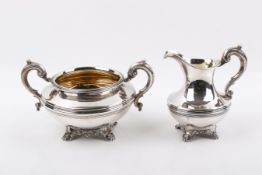 A matching Stirling silver cream jug and sugar bowl.