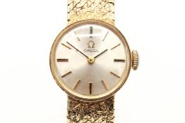 A 9ct gold Omega cocktail watch. Gold markers to the round pearlised face, case diameter 1.
