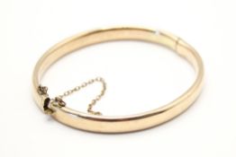 A 9ct gold bangle.