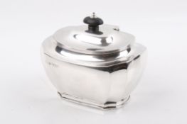 A Stirling silver lidded tea caddy with ebonized finial and plinth base.