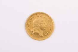 An 1810 George III gold third of a guinea coin. Diameter 17mm, weight 2.78g.