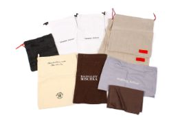 A collection of designer dust bags for clothing and accessories.