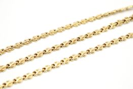 A matching yellow metal necklace and bracelet.