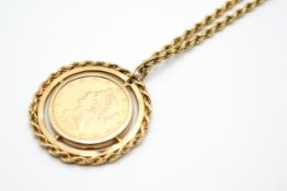 A mounted American 1885 gold ten dollar coin suspended from an unmarked chain.
