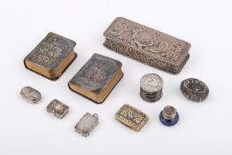 A group of silver and white metal trinket boxes and prayer books.