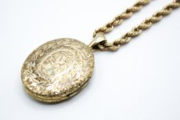 An oval gold plated hinged picture locket with 9ct gold rope link chain.