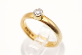 A 22ct gold and diamond solitaire ring. The round cut diamond of circa 0.