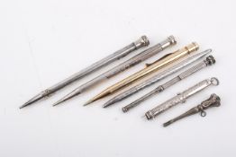Seven silver and white metal pens and propelling pencils. Including a stamped 'Tiffany & Co.