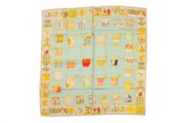 A Gucci silk scarf. In blue, yellow and pink tones, featuring Classical figures and teacups, 86.