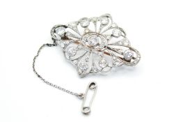 An antique open panel diamond set brooch. Of pierced, lobed from, estimated total diamond weight 1.