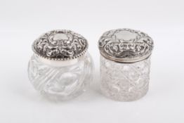 Two silver topped glass jars.
