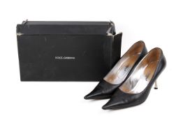 A pair of black leather Dolce & Gabbana stiletto shoes.