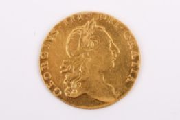 A 1764 George III gold guinea. In very fine condition, very rare date. Diameter 25mm, weight 8.4g.