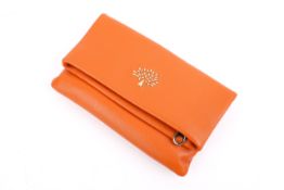 A Mulberry small orange leather clutch bag.