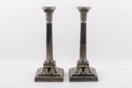 A pair of weighted Stirling silver hallmarked Corinthian column candlesticks.