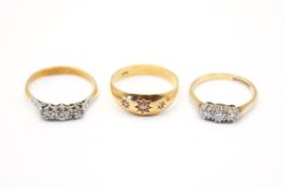 Three 18ct gold and diamond rings.