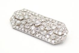 An Art Deco diamond and platinum panel brooch signed Lacloche Frères.
