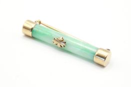 A yellow metal set brooch of barrel form.