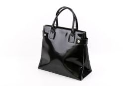 A black patent Gucci tote handbag.