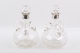 A pair silver mounted carafes.