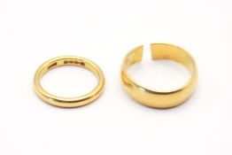 Two 22ct gold wedding bands (one cut). One size K/L, the second circa size R (cut).