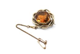 A yellow metal citrine brooch. With closed back, the faceted stone circa 1.8cm x 1.