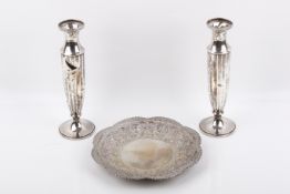 A group of three white metal items.