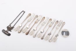 A group of assorted white metal items.