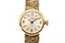 A 9ct gold Omega cocktail watch. Gilt markers to the champagne face, case diameter 1.