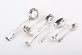 A group of seven assorted white metal flatware mostly spoons.