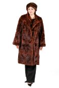 A ladies vintage faux fur coat and a brown mink fur hat.