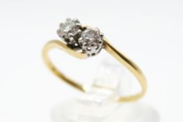 A two-stone diamond crossover ring. Set with two old cut diamonds of 0.