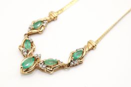 A hallmarked 9ct gold necklet with emerald and diamond set centrepeice. Marquise cut emeralds of 0.
