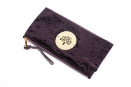 A Mulberry Daria clutch bag in grape ostrich velvet.