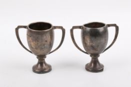 A pair of silver miniature trophies.