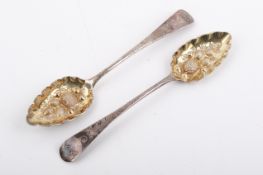 A pair of Georgian Stirling silver hallmarked berry spoons. Having embossed gilt bowls.