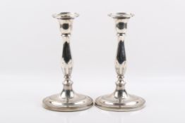 A pair of George III weighted silver candlesticks.