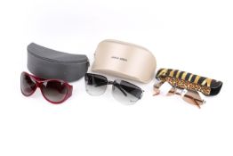 Three pairs of ladies designer sunglasses.