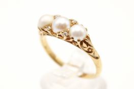 A late Victorian/Edwardian pearl and diamond dress ring. Set with three half cultured pearls from 4.