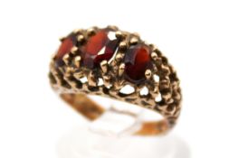 A 9ct gold three stone garnet set ring.