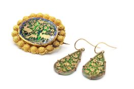 A yellow metal panel brooch and earring set.