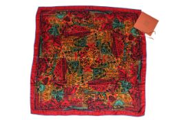 A large red ground Loewe Modernismo Catalan silk scarf.