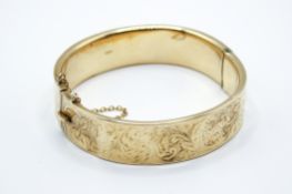A 9ct gold bangle.