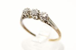 An 18ct three stone diamond ring. With graduated illusion set stones, largest circa 0.