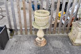 A large reconstituted stone pedestal and a garden pot.