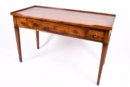 A 20th century Georgian style oak writing table or desk with three drawers.