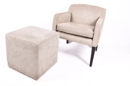 A modern armchair and matching stool.