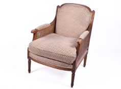 A 20th century caned Bergere style armchair.