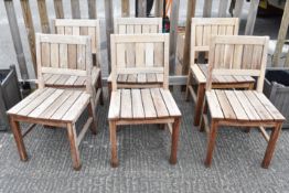 Six modern hardwood garden chairs.