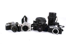 A group of assorted 35mm film cameras and lenses. Including Olympus OM10 and OM30, etc.